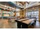 Well-equipped game room with shuffleboard, pool tables, and vintage decor for entertainment at 4832 S Ferric --, Mesa, AZ 85212