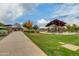 Community lawn space including covered picnic areas surrounded by mature landscaping and neighborhood walkways at 4832 S Ferric --, Mesa, AZ 85212