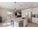 Bright, modern kitchen features an island with a sink and stainless steel appliances at 4832 S Ferric --, Mesa, AZ 85212