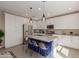Modern kitchen with a spacious center island, white cabinets, stainless steel appliances, and stylish pendant lighting at 4832 S Ferric --, Mesa, AZ 85212