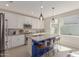 Modern kitchen featuring a large island, white cabinetry, stainless steel appliances, and a view of the backyard at 4832 S Ferric --, Mesa, AZ 85212