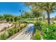 Landscaped walkway with lush greenery, flowers, and decorative plants, creating a serene and inviting outdoor space at 4832 S Ferric --, Mesa, AZ 85212