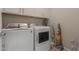 Bright laundry room features white washer and dryer, overhead cabinets, and storage space at 4832 S Ferric --, Mesa, AZ 85212