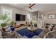 Comfortable living room featuring modern furnishings, a large TV, and a staircase leading to the upper level at 4832 S Ferric --, Mesa, AZ 85212