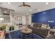 Stylish living room with a striking blue accent wall, comfortable seating, and a staircase leading to the upper level at 4832 S Ferric --, Mesa, AZ 85212