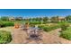 Outdoor seating area with tables and chairs, surrounded by manicured landscaping and community amenities at 4832 S Ferric --, Mesa, AZ 85212