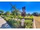Community pet station with waste bags and disposal bin near sidewalk, landscaping, and grass at 4832 S Ferric --, Mesa, AZ 85212