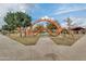 Community playground featuring orange jungle-gym climbing features and a vibrant blue sky at 4832 S Ferric --, Mesa, AZ 85212