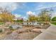 Scenic pond with trees and boulder landscaping, showcasing a peaceful neighborhood setting at 4832 S Ferric --, Mesa, AZ 85212