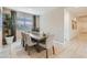 Serene dining room with a large dining table, six chairs, and neutral decor at 5027 S 233Rd Dr, Buckeye, AZ 85326