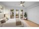 Bright bedroom with a ceiling fan, hardwood floors, and plenty of natural light at 5211 N 24Th St # 104, Phoenix, AZ 85016