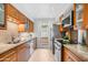 Well-lit kitchen featuring stainless steel appliances, granite countertops, and hardwood cabinetry at 5211 N 24Th St # 104, Phoenix, AZ 85016