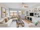 Inviting living room offering a ceiling fan, built-in shelving, comfortable seating, and bright windows at 5211 N 24Th St # 104, Phoenix, AZ 85016