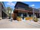 A modern restaurant exterior with outdoor seating, landscaping, and a sleek design in a bustling area at 5211 N 24Th St # 104, Phoenix, AZ 85016