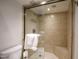 Modern tiled shower with glass door, rainfall showerhead, and built-in bench at 5211 N 24Th St # 104, Phoenix, AZ 85016