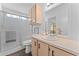 Bathroom featuring a shower, vanity with framed mirror and warm wood cabinets at 5735 E Mcdowell Rd, Mesa, AZ 85215