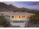 Luxury desert home with a tranquil pool and expansive patio amidst scenic mountain and desert landscape at 6602 N Arizona Biltmore Cir, Phoenix, AZ 85016