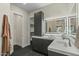 Well-lit bathroom featuring sleek vanity, modern fixtures, and convenient closet access at 6602 N Arizona Biltmore Cir, Phoenix, AZ 85016