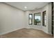 Bright bedroom with sleek hardwood floors and stylish black frame windows offering natural light and neighborhood views at 6602 N Arizona Biltmore Cir, Phoenix, AZ 85016