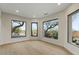 Sunlit bedroom with hardwood floors and expansive windows that capture scenic neighborhood views for an inviting space at 6602 N Arizona Biltmore Cir, Phoenix, AZ 85016