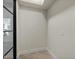 Empty room with tile floors, white walls, baseboards and black framed windows at 6602 N Arizona Biltmore Cir, Phoenix, AZ 85016