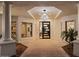 Stunning home entrance with contemporary lighting, columns, modern door, and desert landscaping at 6602 N Arizona Biltmore Cir, Phoenix, AZ 85016
