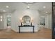 Bright foyer with hardwood floors, elegant lighting, and a decorative mirror reflecting the entrance at 6602 N Arizona Biltmore Cir, Phoenix, AZ 85016