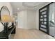 Modern foyer with a black front door, stylish console table, and hardwood floors, creating a welcoming entrance at 6602 N Arizona Biltmore Cir, Phoenix, AZ 85016