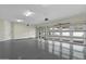 Spacious garage with epoxy flooring, bright lighting, and a large windowed garage door at 6602 N Arizona Biltmore Cir, Phoenix, AZ 85016