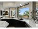 Modern kitchen featuring marble countertops, sleek black cabinetry, and a scenic view at 6602 N Arizona Biltmore Cir, Phoenix, AZ 85016