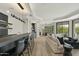 A large sectional sofa sits adjacent to the wet bar and outdoor living space at 6602 N Arizona Biltmore Cir, Phoenix, AZ 85016