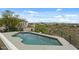 Backyard pool with a view of neighboring houses and distant mountains at 6602 N Arizona Biltmore Cir, Phoenix, AZ 85016