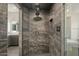 Modern shower with a rainfall showerhead and custom gray tile at 6602 N Arizona Biltmore Cir, Phoenix, AZ 85016