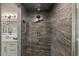 Contemporary shower with a rainfall showerhead and custom gray tile at 6602 N Arizona Biltmore Cir, Phoenix, AZ 85016