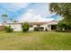 Large grassy yard with mature lemon trees and a white house at 7844 N 17Th Ave, Phoenix, AZ 85021