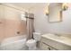 Bathroom with classic finishes, featuring pink tiling and a shower-tub combination at 7844 N 17Th Ave, Phoenix, AZ 85021