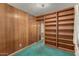 Cozy bedroom with wood paneling, and built-in shelving at 7844 N 17Th Ave, Phoenix, AZ 85021