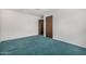 Neutral bedroom featuring plush green carpet, white walls, and classic wooden doors at 7844 N 17Th Ave, Phoenix, AZ 85021
