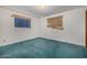Bright bedroom featuring two windows with shades, plush green carpet, and neutral walls at 7844 N 17Th Ave, Phoenix, AZ 85021