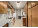 Galley-style kitchen with wood cabinets, white countertops, and functional appliances at 7844 N 17Th Ave, Phoenix, AZ 85021