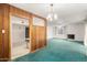 Spacious living room showcasing wood paneling, ceiling fan, and an open doorway to another room at 7844 N 17Th Ave, Phoenix, AZ 85021