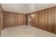 Inviting living room featuring classic wood paneling and neutral flooring for a warm, comfortable ambiance at 7844 N 17Th Ave, Phoenix, AZ 85021