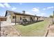 Spacious backyard with a covered patio, a well-maintained lawn, and a garden at 8354 W Surrey Ave, Peoria, AZ 85381
