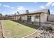 Expansive backyard featuring a covered patio, lush green lawn, and mature landscaping, perfect for outdoor living at 8354 W Surrey Ave, Peoria, AZ 85381