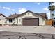 Inviting single-story home with a two-car garage, desert-style landscaping, and a well-maintained exterior at 8354 W Surrey Ave, Peoria, AZ 85381