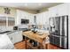 Modern kitchen featuring white cabinets, stainless steel appliances, granite countertops and a butcher block island at 8354 W Surrey Ave, Peoria, AZ 85381