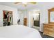 Bright main bedroom featuring a walk-in closet and an ensuite bathroom with wood cabinets at 8354 W Surrey Ave, Peoria, AZ 85381