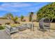 Seating area with modern patio furniture by the pool and fire pit at 9422 E Southwind Ln, Scottsdale, AZ 85262
