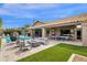 A backyard featuring a pool, ping pong table, and outdoor seating area at 9422 E Southwind Ln, Scottsdale, AZ 85262