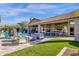 A spacious backyard with a pool, ping pong table, and seating area around a fire pit at 9422 E Southwind Ln, Scottsdale, AZ 85262